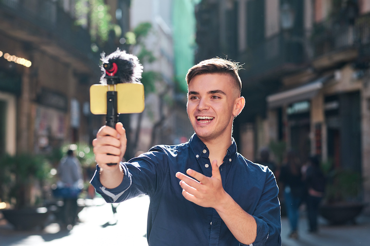 Young professional recording selfie video in the street